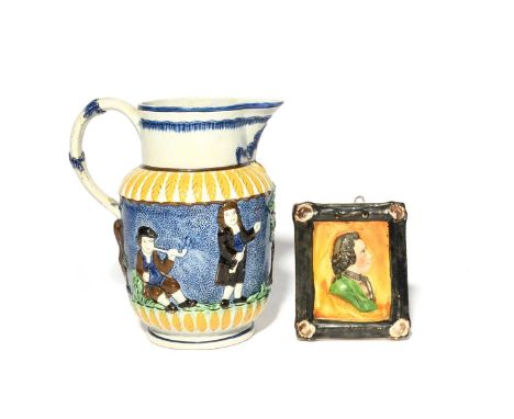 A Pratt ware 'Parson, Clerk and Sexton' jug, early 19th century, moulded in relief with the three titled characters drinking 
