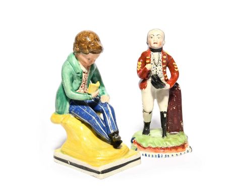 A Staffordshire figure of a British army veteran, c.1810-20, wearing the red coat of his uniform, his left leg replaced with 