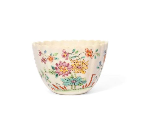 A rare Chelsea fluted teabowl, c.1750-52, the fluted form painted in famille rose enamels with flowering plants and lotus, th