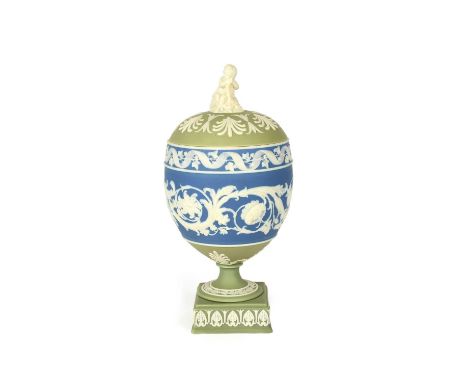 A Wedgwood tri-colour Jasperware vase and cover, 19th century, applied with a continuous floral scroll design in white on a b