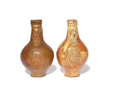 Two Rhenish stoneware bellarmines (Bartmannskrug), 17th/18th century, each with a floral or mask roundel to the body beneath 