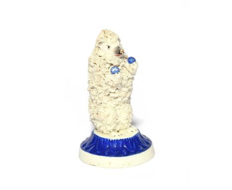 A rare Staffordshire porcelain figure of a juggling hedgehog, 19th century, standing on its back paws with a blue ball in eac