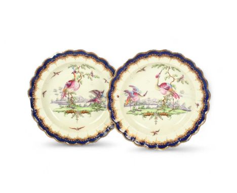 A pair of Worcester dessert plates of 'Lord Rodney' type, c.1780, finely painted with colourful birds standing before buildin