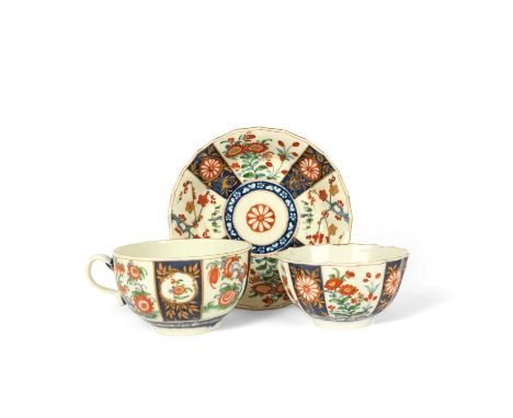 A Worcester teabowl and saucer, c.1770, the Warmstry-fluted bodies decorated in a panelled Japan pattern with flowering plant