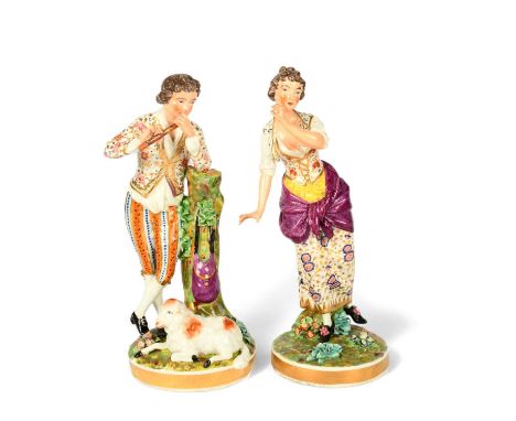 A pair of Bloor Derby figures of a shepherd and his companion, c.1820, he standing beside and leaning on a tree stump, playin