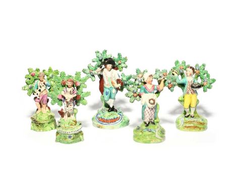 Two pairs of Staffordshire figures of children, 1st half 19th century, one pair Walton and modelled holding a bird and a nest