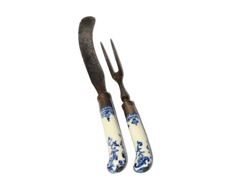 A St Cloud dessert knife and fork, c.1720-40, the handles of pistol grip form and painted in underglaze blue with a formal de