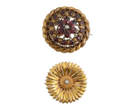 A Victorian garnet and yellow gold brooch of open-work design, centrally set with a half pearl and garnet floral cluster, wit