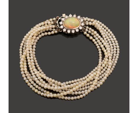 An opal, diamond-set and seed pearl multi strand braceletthe seven row seed pearl bracelet to the oval opal cabochon and diam