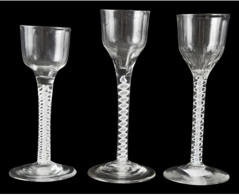 Three 18th century opaque twist wine glasses c.1760-5first ogee shaped bowl on a single series containing a multi-ply corkscr