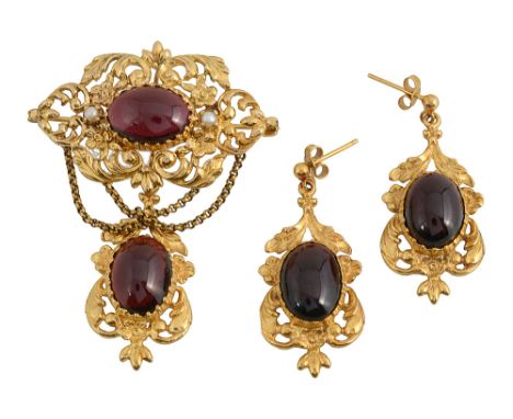 Victorian style garnet brooch and ear pendants a 9ct gold scrolling floral and foliate mount set with a central garnet caboch