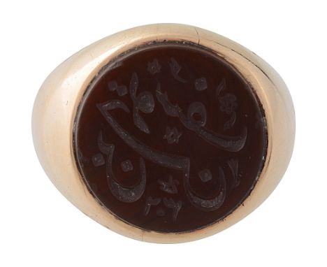 A carnelian set signet ringchased with Islamic text to surfacering size O, approx weight 10.4gCondition: 