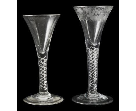 Two mid 18th century mercury twist wine glasses c.1750first drawn trumpet bowl engraved with fruiting vine on four spiral thr