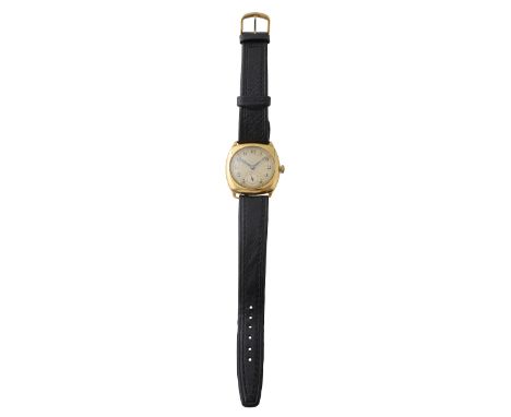 An 18ct gold 1930s manual wind wrist watchthe engine turned dial with Arabic numerals, moon hands and subsidiary seconds, wit