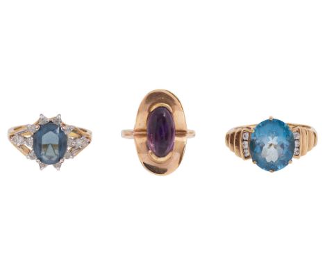 Three gem-set ringsthe first set with an oval blue topaz to the white stone stepped shoulders, 9ct yellow gold shank, Birming