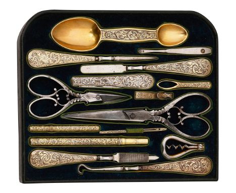 A mid Victorian fitted tray of mostly silver-gilt tools from a dressing boxfoliate engraved decoration, comprising a Victoria