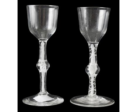 Two 18th century opaque twist wine glasses c.1760with ogee shaped bowls raised on central knopped stems, one double series wi