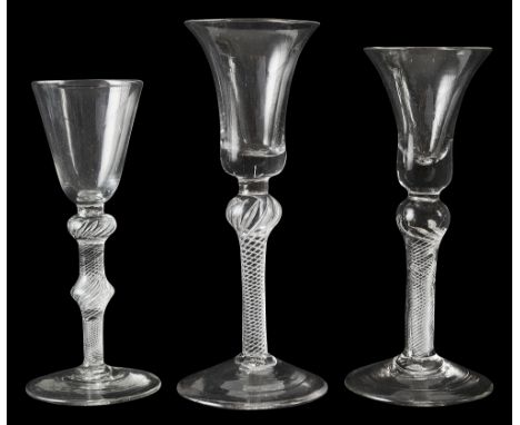 Three mid 18th century air twist wine glasses c.1750first bell shaped  bowl on a multi spiral stem with shoulder knop, second