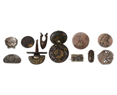 A collection of Japanese buttons, plaques and mountscomprising a silver and gilt shishi mask button, a silver dragon button, 