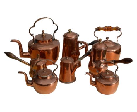 Three late Georgian century copper coffee pots, a brandy pan and four  kettlesthe coffee pots of various sides with turned wo