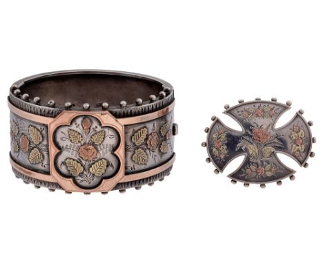 A Victorian silver hinged bangleapplied two-coloured floral and foliate motifs with chased abstract design and chased floral 