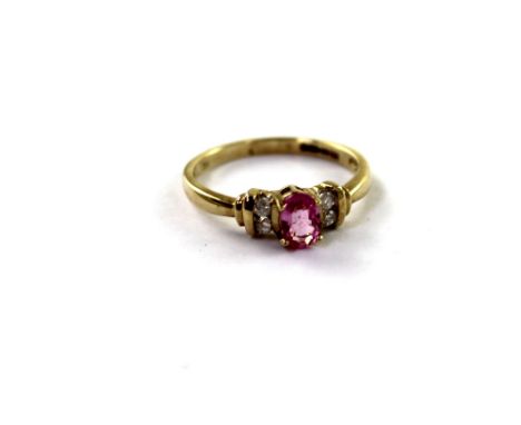 A 9ct yellow gold ladies' dress ring with pink central sapphire and four small diamonds, size O, approx 2.1g.