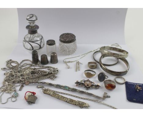 A collection of silver jewellery, thimbles and dressing table furniture to include silver bangles, a late Victorian silver an