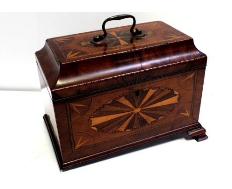 A 19th century mahogany inlaid sarcophagus tea caddy with interior lids and lead lining (lacking tea canisters), to four shap