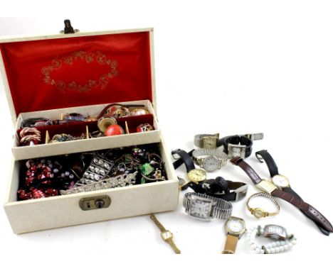 A cream faux leather jewellery box containing a quantity of vintage and contemporary costume jewellery to include rings, watc