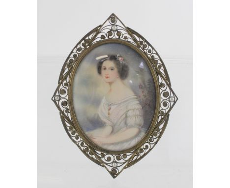 A portrait miniature of a young woman in period costume with flowers in her hair, 8.5 x 7cm, in an oval filigree and pearl me