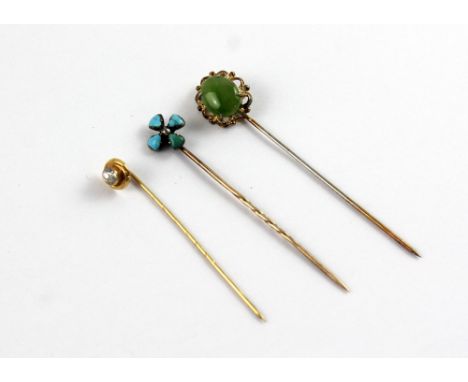 Three 9ct gold stick pins, one with small solitaire white stone, one floral-set with small white stone and turquoise and one 