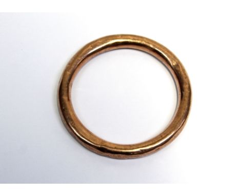 A rose gold coloured bangle, marked 9ct, approx 18g.