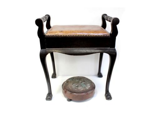 A 19th century mahogany piano stool, lift-up hide-covered seat for storage of music, to cabriole supports and ball and claw f