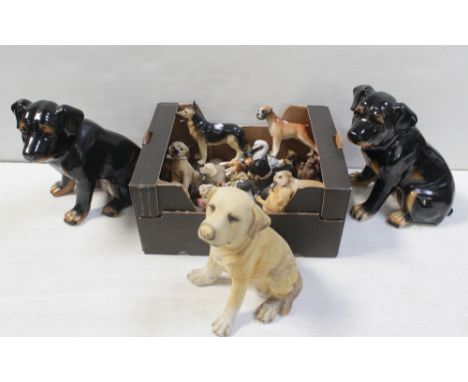 Two large ceramic models of dogs and a collection of various dog figures to include German Shepherd, spaniels and models of o