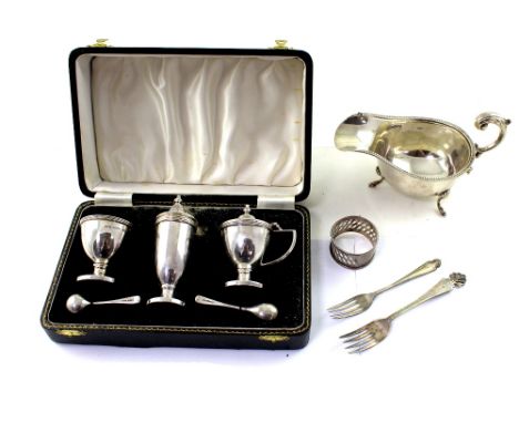 An Elizabeth II hallmarked silver three-piece cruet comprising pepper pot, mustard and table salt and a George V hallmarked s