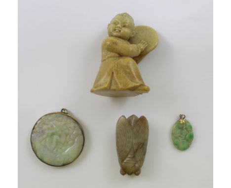 A collection of carved stone items to include a carved celadon jade disc with veins of amethyst and green, diameter approx 5.