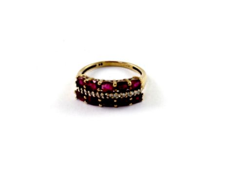 A 9ct yellow gold ladies' dress ring set with red stones and chip diamonds (one diamond missing), size O1/2, approx 3g.