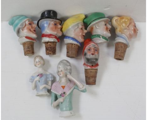 Six early 20th century ceramic bottle stoppers in the form of clown heads and two German dolls' heads (8).