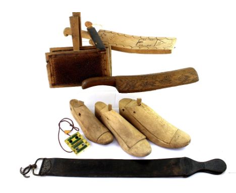 An early 20th century Swedish folk items to include a 1919 folk art paddle, a Swedish laundry bat, various wooden shoe casts 