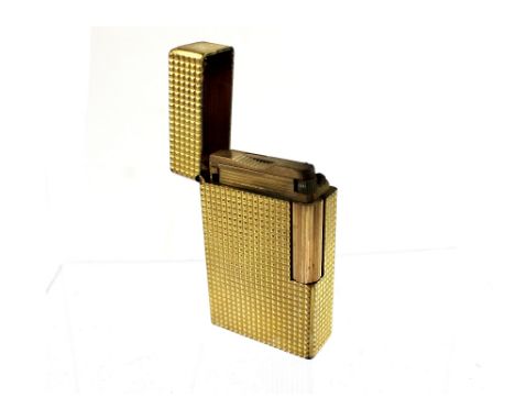 A vintage Dupont, France yellow metal engine-turned cigarette lighter with 'S Dupont Paris, Made in France' engraved to the b