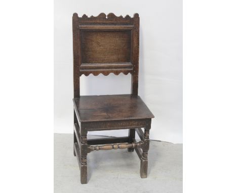 An 18th century oak panel-back hall chair with shaped top rail, lower apron and on bobbin-turned supports, height 102.5cm.