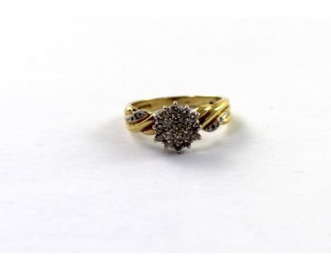 A 9ct yellow gold ladies' dress ring set with small white diamonds and tiny diamonds to twist shoulders, size N, approx 4.1g.