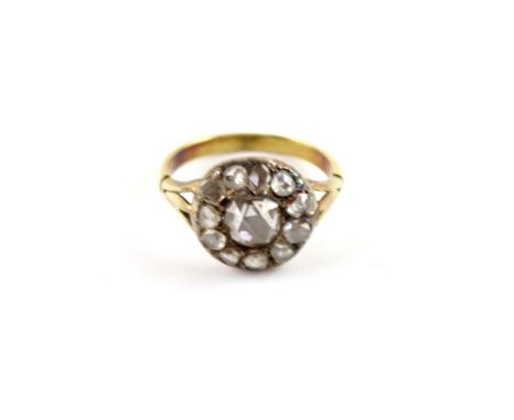 A Georgian yellow metal ladies' dress ring, floral-set with central diamond and diamond surround, size J, approx 3.6g.