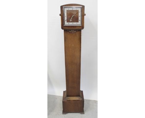 A 1930s oak cottage longcase cloak, the silvered square chapter ring set with Roman numerals, driven by a twin-train movement