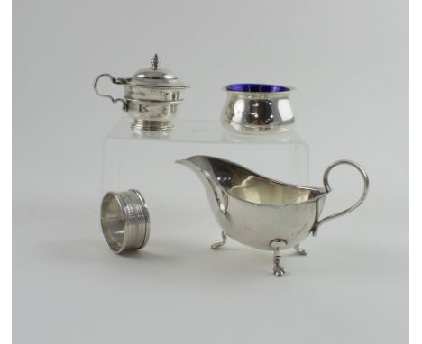 A group of hallmarked silver items to include a sauce boat, single napkin ring, a mustard pot with blue liner (lacking spoon)