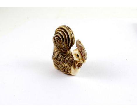 An early 20th century Japanese ivory netsuke in the form of a hen, with red character mark to the base.