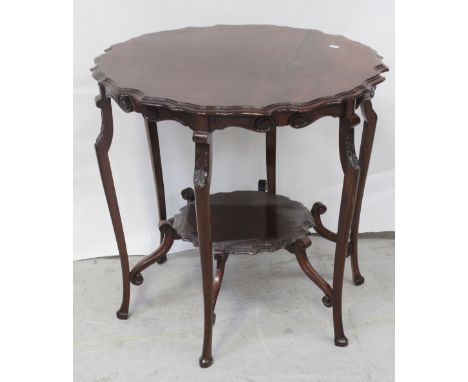 A mid-20th century mahogany occasional table with curved rim to lower matching shelf, on cabriole supports, diameter 70cm.