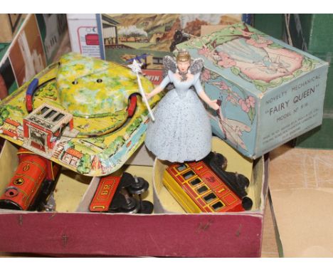 A small collection of vintage tin plate toys comprising a Bryntoy clockwork locomotive, tender and carriage with track and si