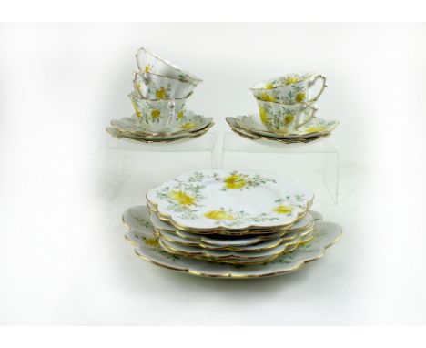 An early/mid-20th century Foley part tea service, white ground with yellow flora. CONDITION REPORT Two of the five cups with 