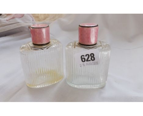 A pair of matching cologne oval bottles with silver and enamel   Screw uncovers – 3.5” high       